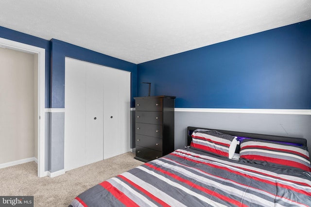 bedroom with light carpet and a closet