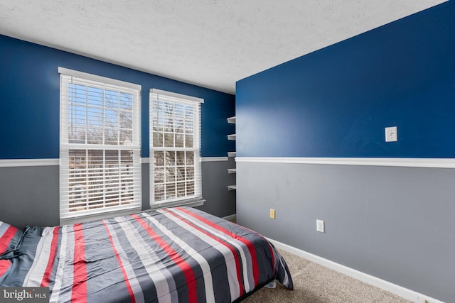 carpeted bedroom featuring a textured ceiling