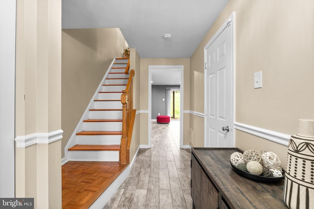 stairway with hardwood / wood-style floors