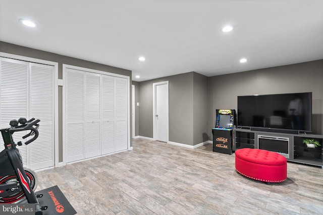 workout area featuring light wood-type flooring