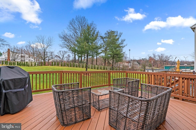 wooden deck featuring a grill and a yard