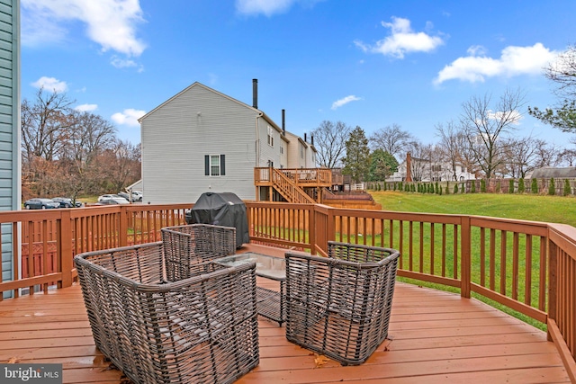 wooden terrace with area for grilling and a lawn