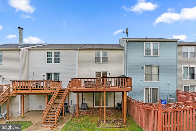 rear view of house featuring a wooden deck and central air condition unit