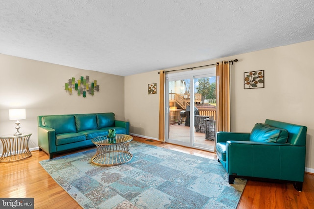 living room with hardwood / wood-style flooring and a textured ceiling