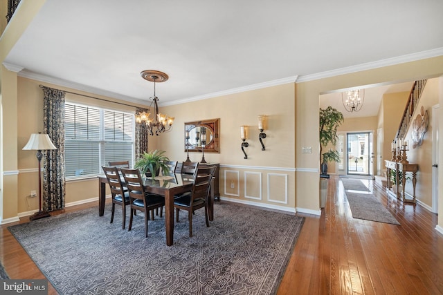 dining room featuring plenty of natural light, dark hardwood / wood-style floors, and a notable chandelier