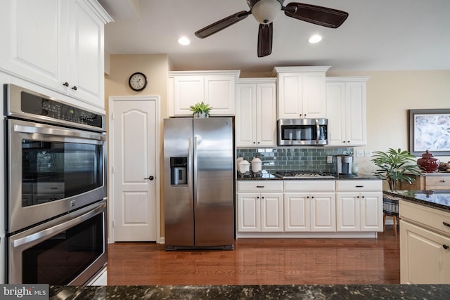 kitchen with white cabinetry, tasteful backsplash, and appliances with stainless steel finishes