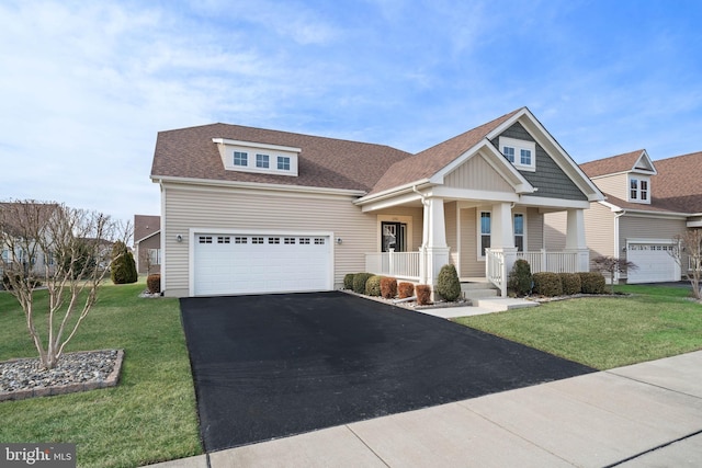 craftsman-style house with a garage, covered porch, and a front lawn