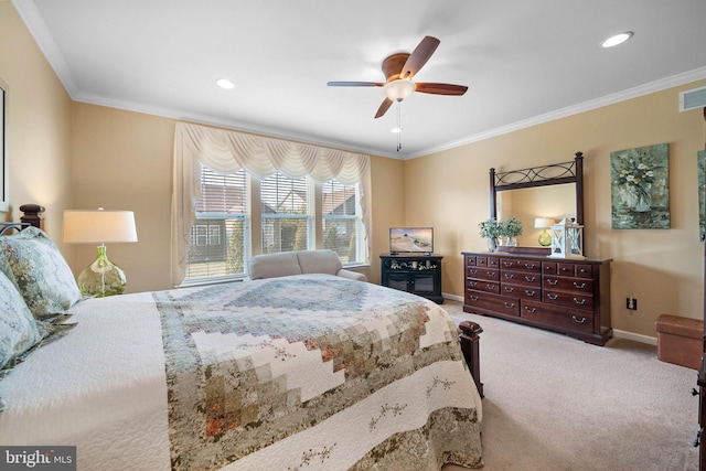 carpeted bedroom with ornamental molding and ceiling fan