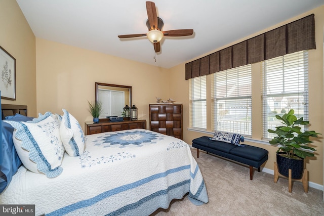 bedroom with ceiling fan and light colored carpet