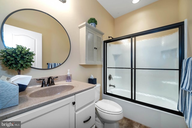 full bathroom with enclosed tub / shower combo, vanity, and toilet