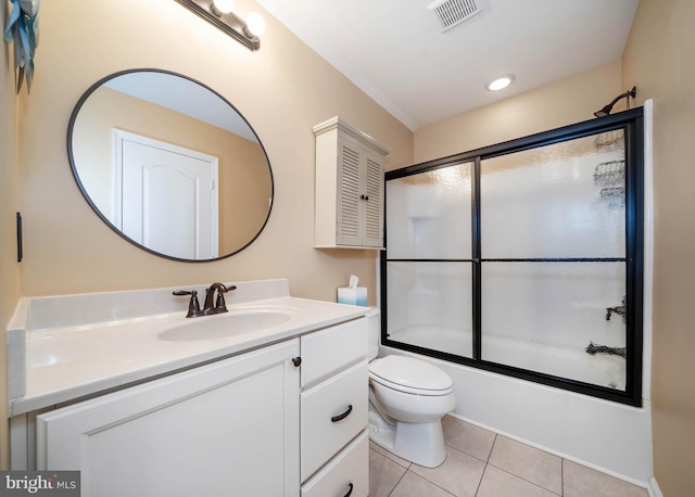 full bathroom with vanity, tile patterned floors, shower / bath combination with glass door, and toilet