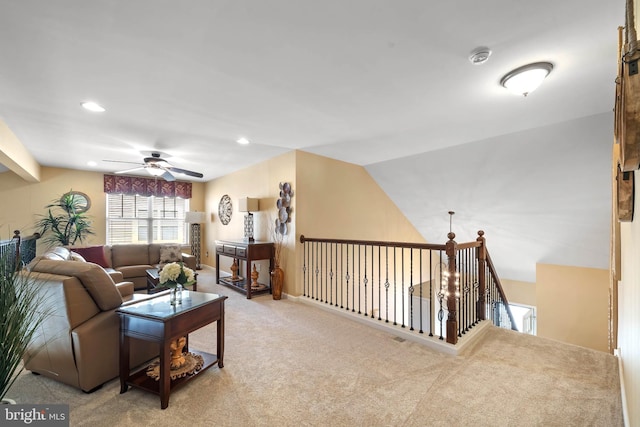 living room featuring lofted ceiling, light carpet, and ceiling fan