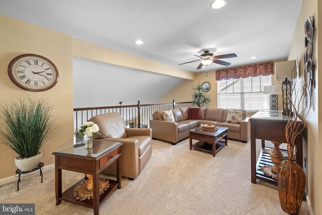 carpeted living room featuring lofted ceiling and ceiling fan