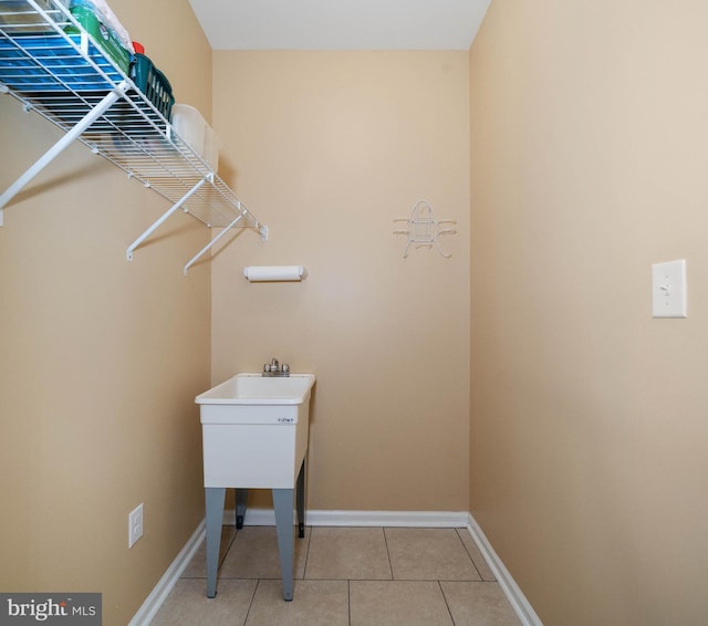 laundry area with light tile patterned flooring