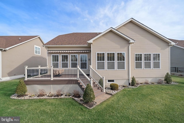 back of property with a wooden deck and a lawn