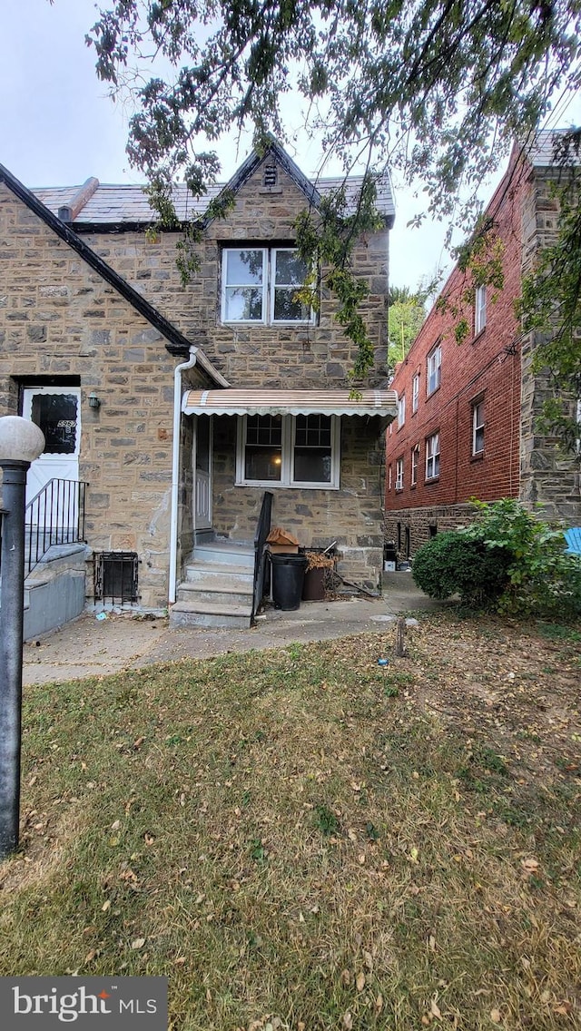 rear view of house with a yard