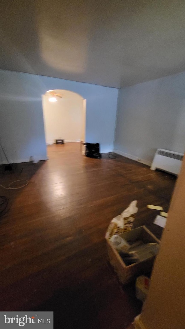 interior space with hardwood / wood-style flooring and radiator