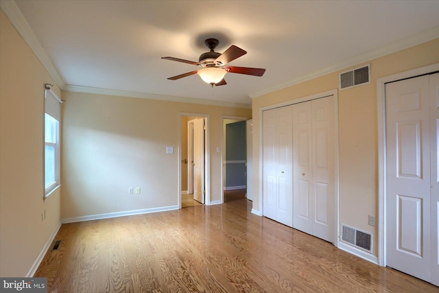 unfurnished bedroom with crown molding, ceiling fan, and light hardwood / wood-style flooring