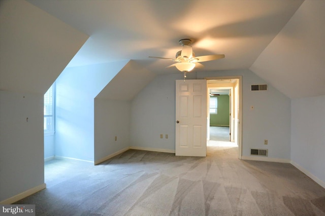 bonus room with lofted ceiling, light carpet, and ceiling fan