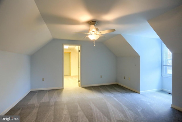 additional living space featuring ceiling fan, lofted ceiling, and light carpet