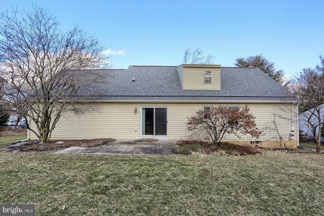 back of house featuring a lawn and a patio