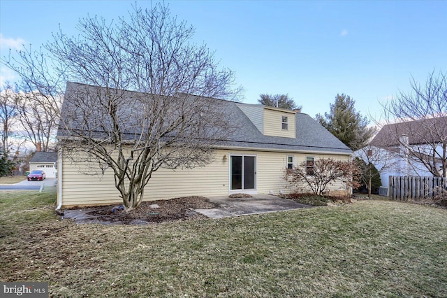 rear view of house with a yard and a patio area