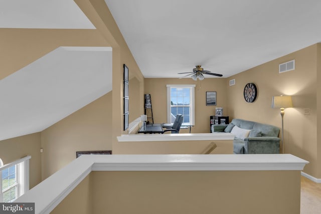 unfurnished living room with ceiling fan and light colored carpet