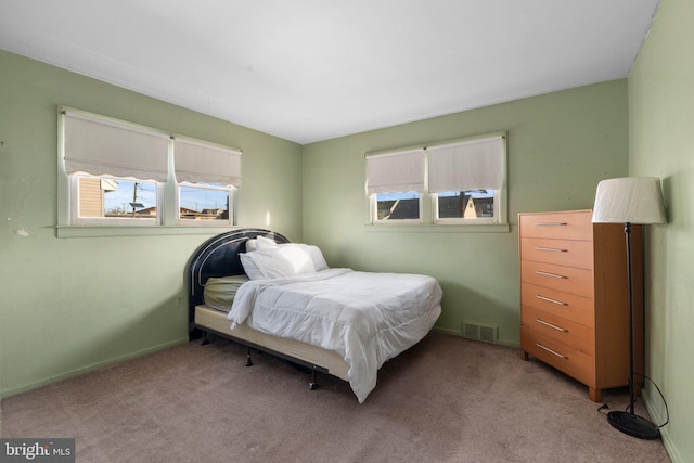 bedroom featuring light colored carpet