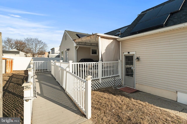 view of side of property featuring solar panels