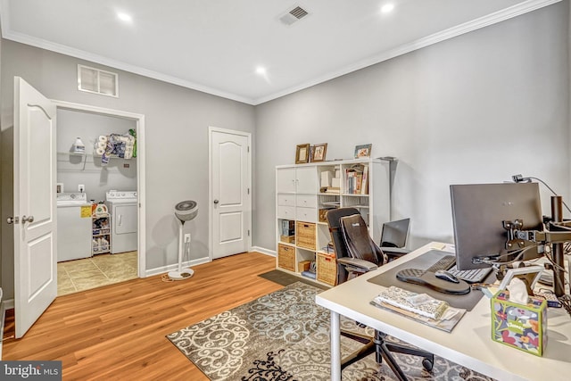 office space featuring hardwood / wood-style flooring, washing machine and clothes dryer, and crown molding