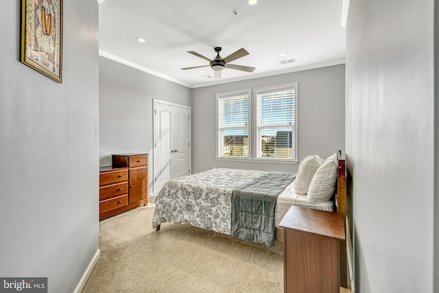 carpeted bedroom featuring ceiling fan, ornamental molding, and a closet