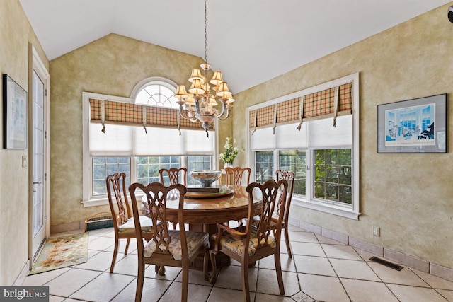 tiled dining space featuring vaulted ceiling and an inviting chandelier