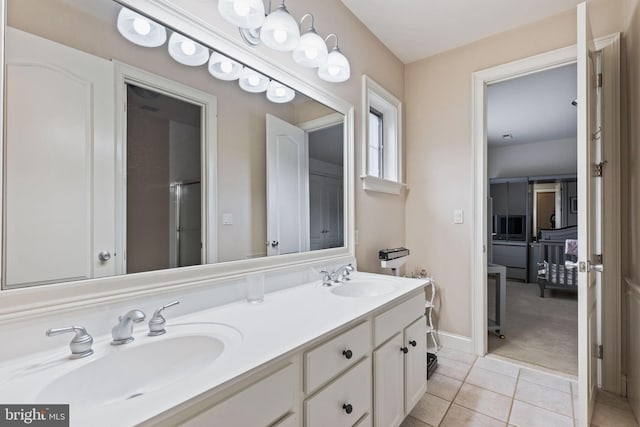 bathroom with tile patterned floors and vanity