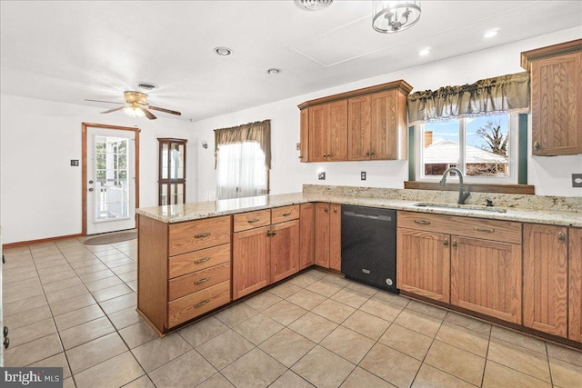 kitchen with light stone countertops, black dishwasher, sink, and kitchen peninsula