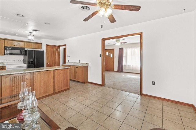 kitchen with ceiling fan, light colored carpet, and black appliances