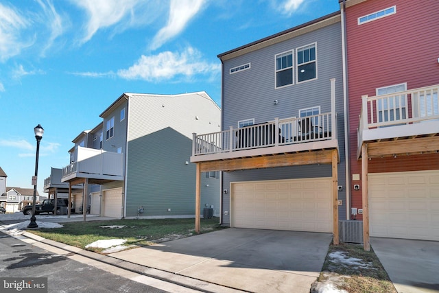 exterior space with a balcony, a garage, and central AC unit