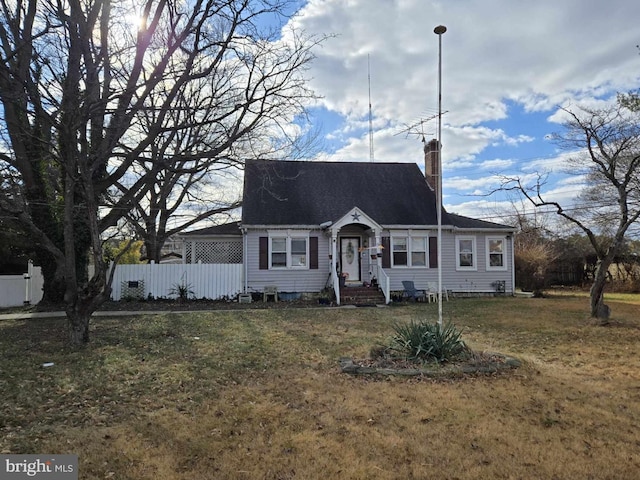 cape cod home with a front lawn