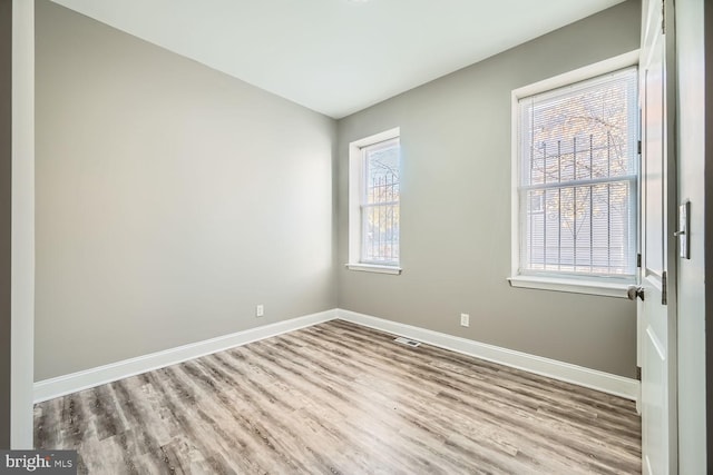 empty room with light hardwood / wood-style flooring