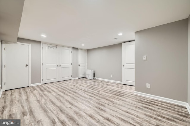 basement with light hardwood / wood-style flooring