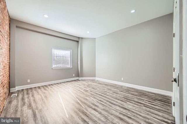 empty room with light hardwood / wood-style flooring