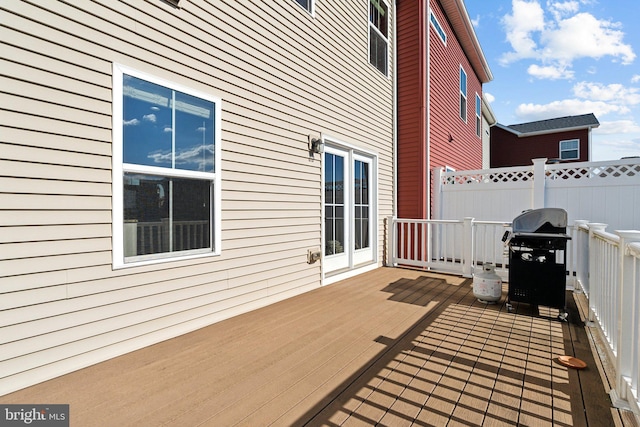 wooden terrace with area for grilling and fence