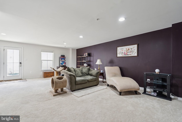 living area with an accent wall, carpet, baseboards, and recessed lighting