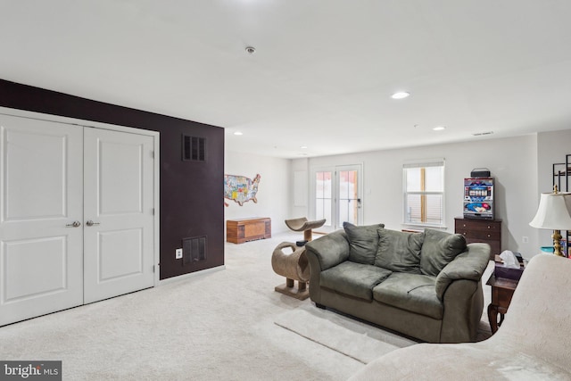 living area with carpet floors, recessed lighting, and visible vents