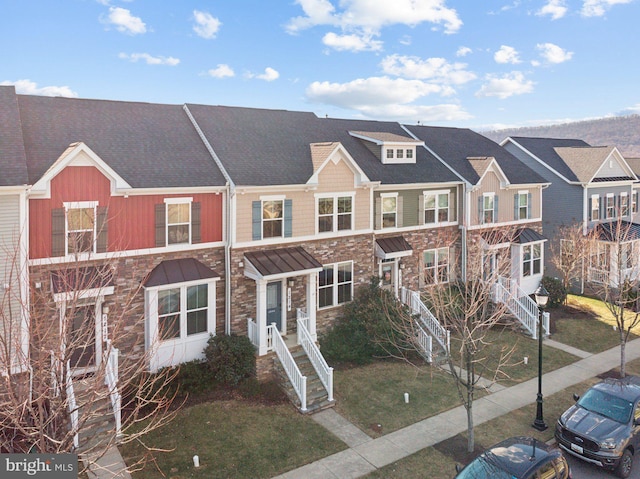 view of property with a residential view and stone siding