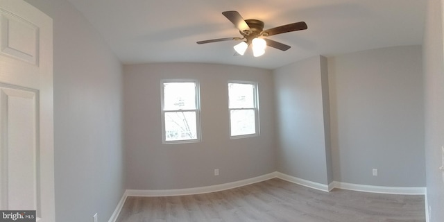 spare room with ceiling fan and light wood-type flooring