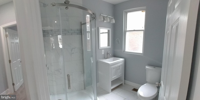 bathroom with vanity, tile patterned flooring, a shower with shower door, and toilet