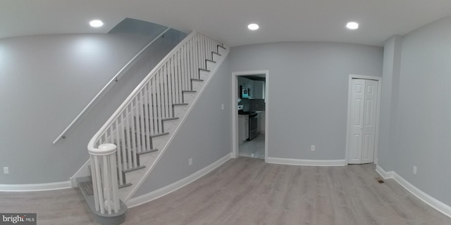 staircase featuring wood-type flooring