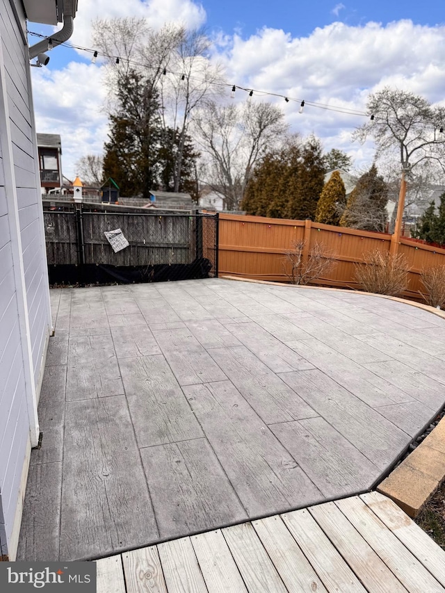 deck featuring a patio and a fenced backyard