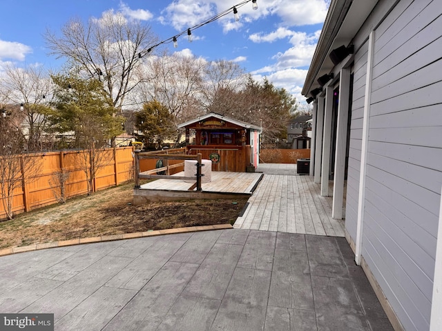 wooden terrace featuring fence