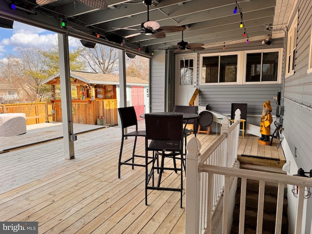 wooden terrace featuring ceiling fan and outdoor dining space